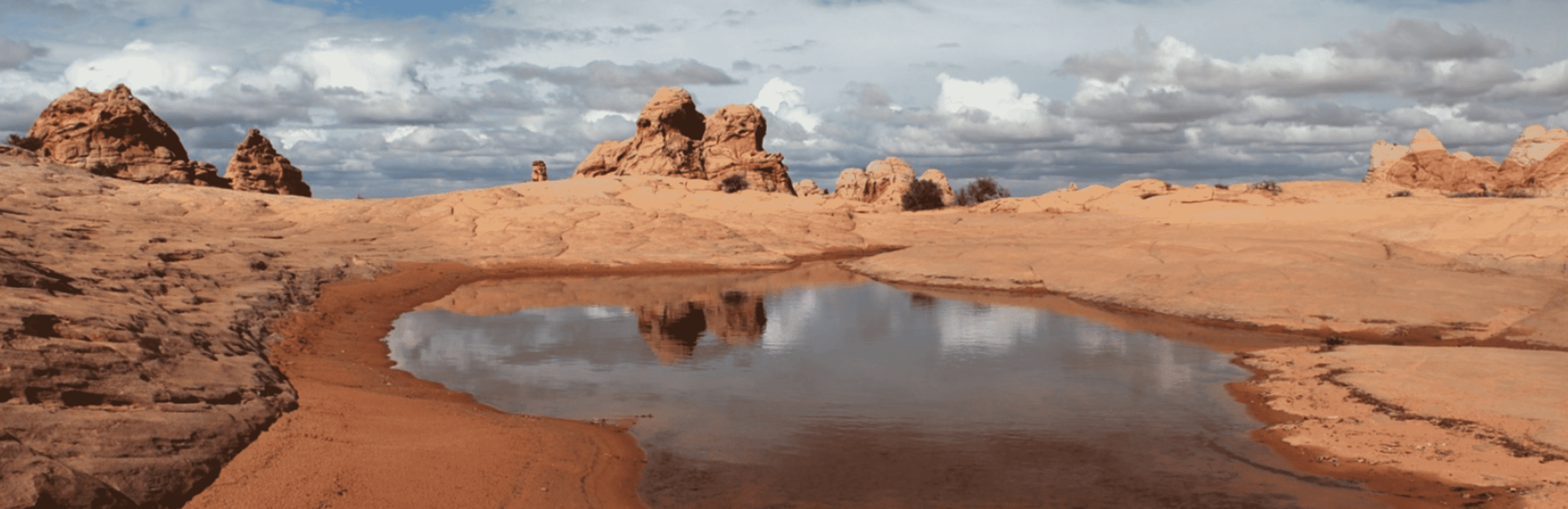 Puddle of water in rocky desert landscape